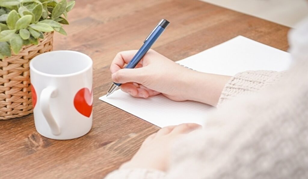 「話し合いのために紙に書いている女性」のイメージ画像